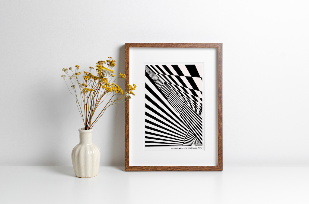 Framed print with geometric monochrome design and lyrics from "The Streets". Featured alongside a decorative vase and flowers.