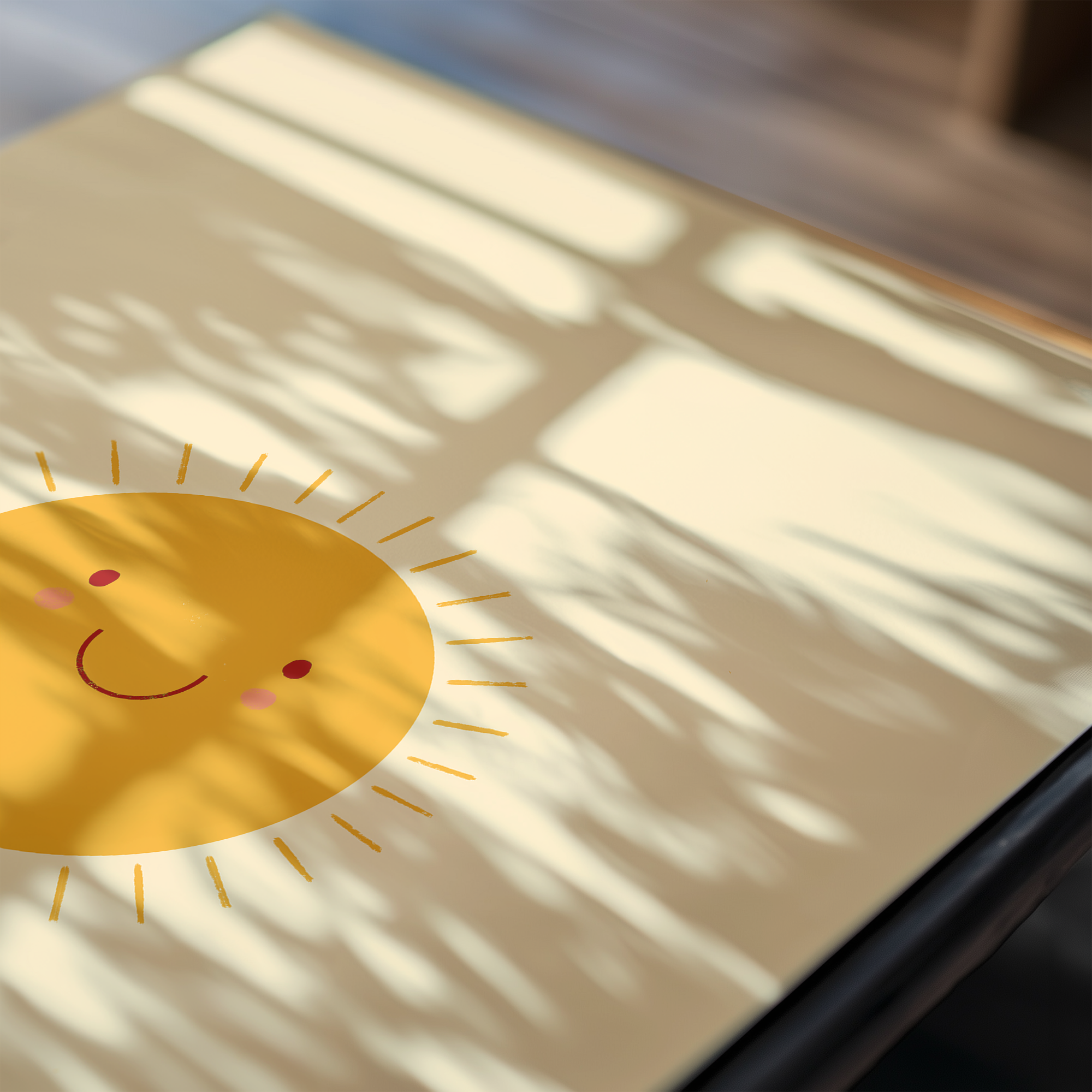 A framed print featuring a smiling orange sun against a yellow background, surrounded by children's aesthetic items and toys.