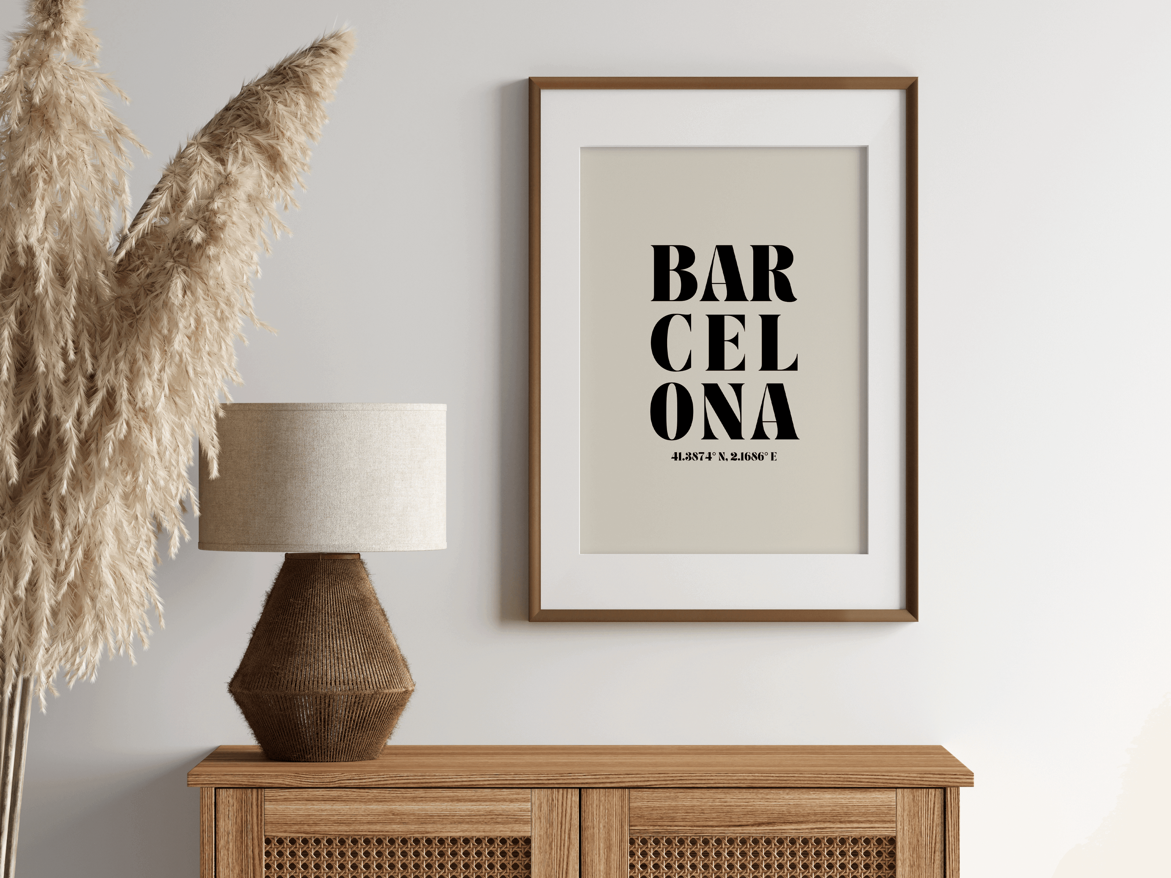 "Barcelona" typography print featuring coordinates, displayed in a wall hung frame in a room with neutral boho decor.