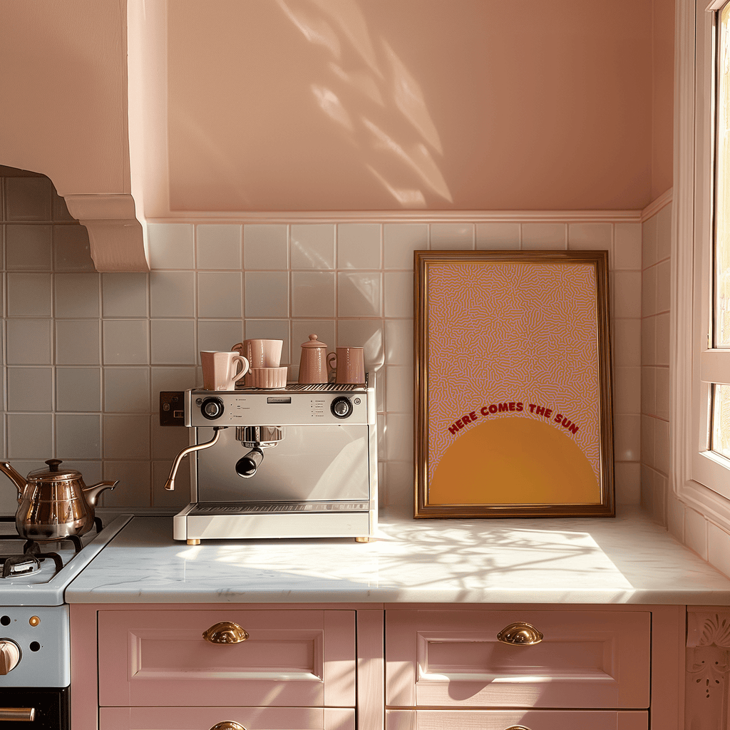 Kitchen with pink cabinets, coffee machine, and a framed art print on the wall.