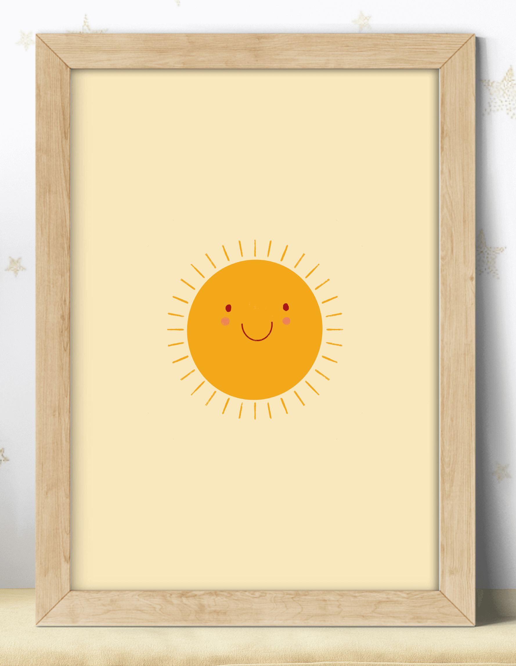 An art print featuring an orange smiling sun against a yellow background, displayed in a wooden frame.