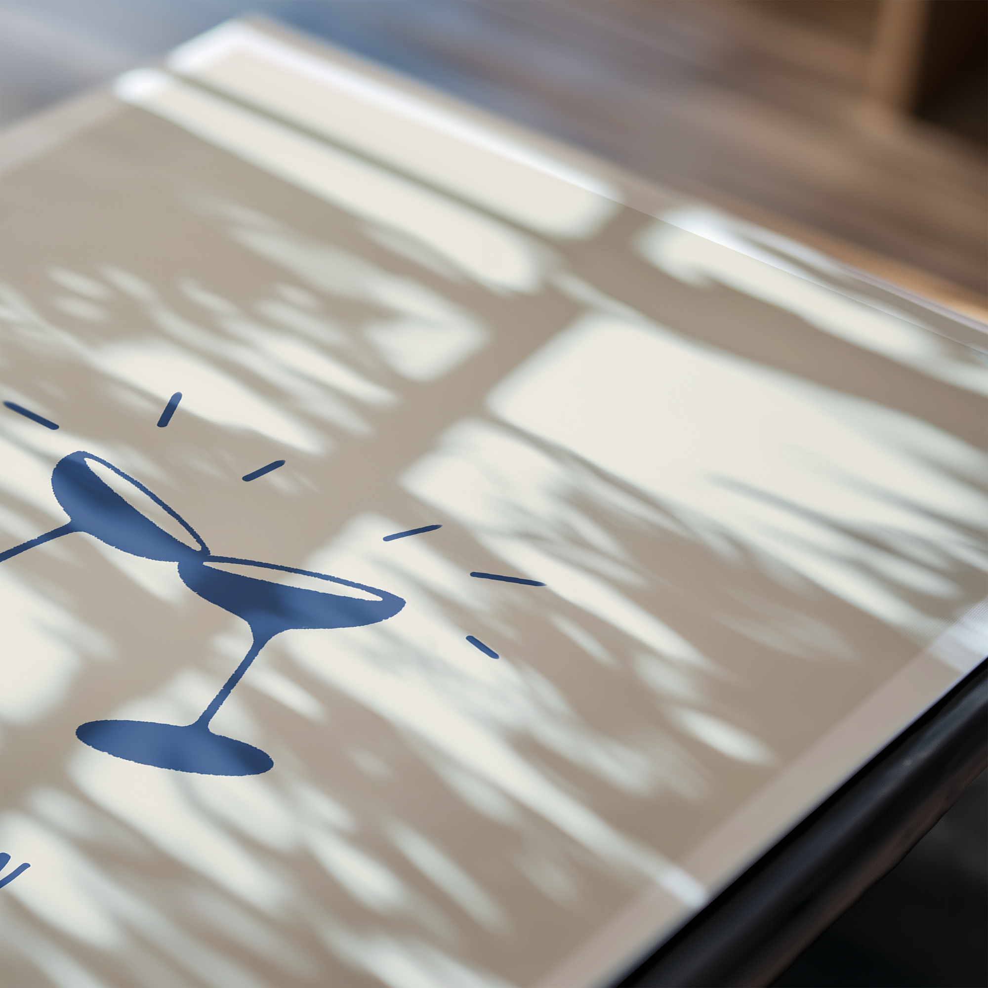 Close up image of "cin cin" art print featuring navy illustration of two champagne coupes with light shadows hitting the print.