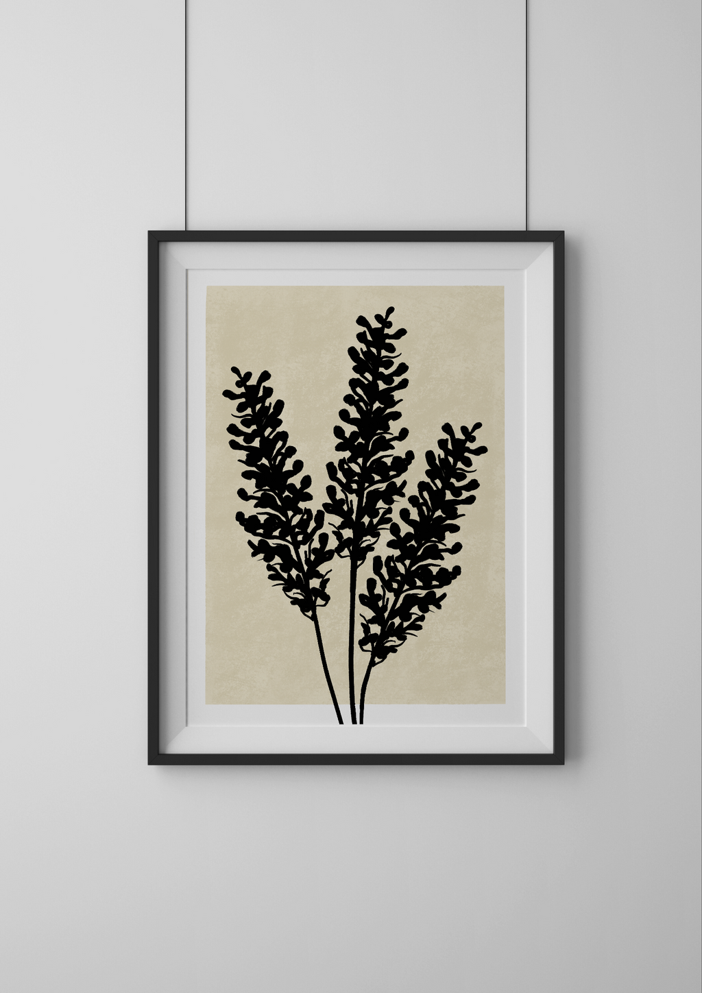 Framed artwork with black botanical design on a beige background