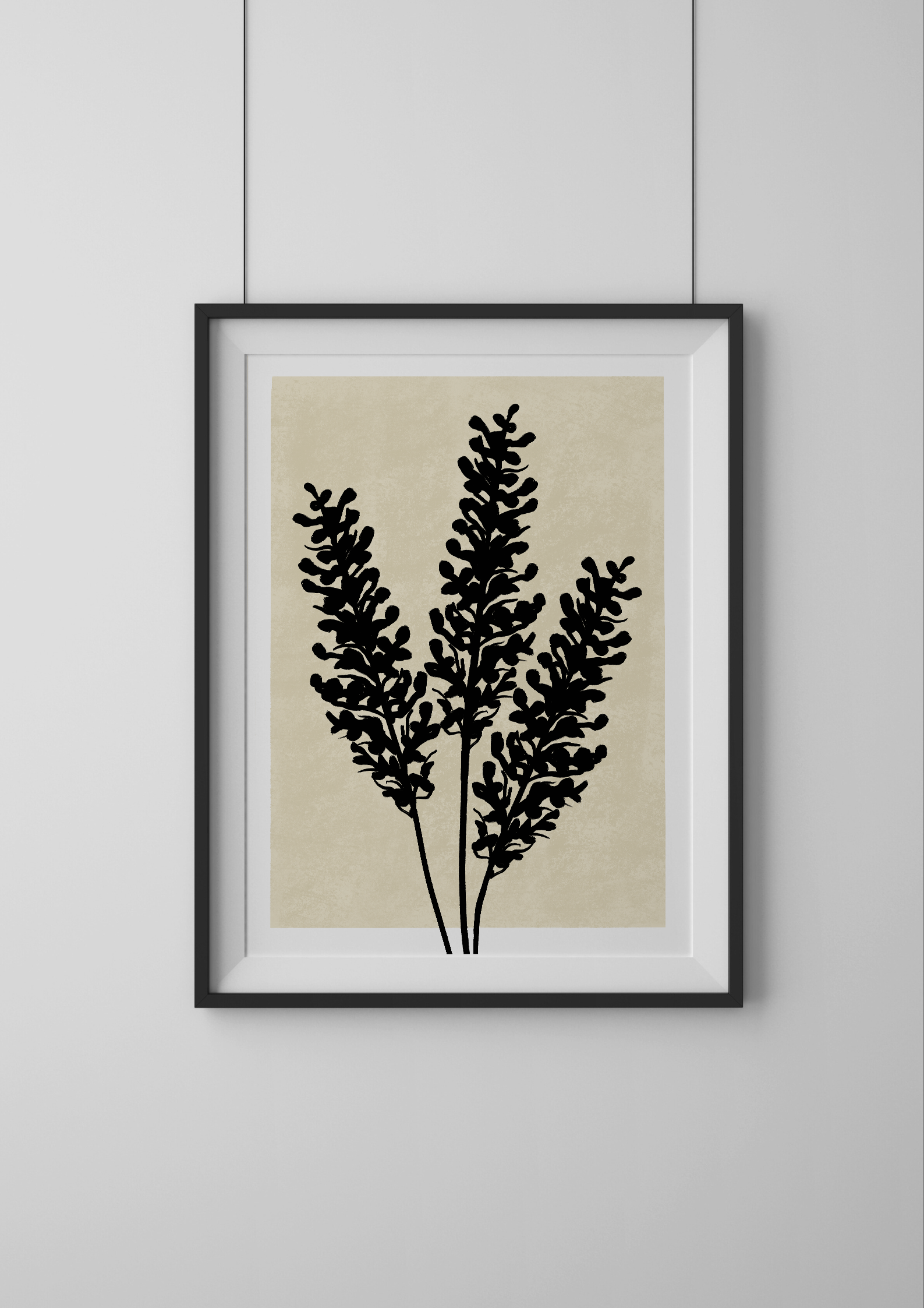 Framed artwork with black botanical design on a beige background