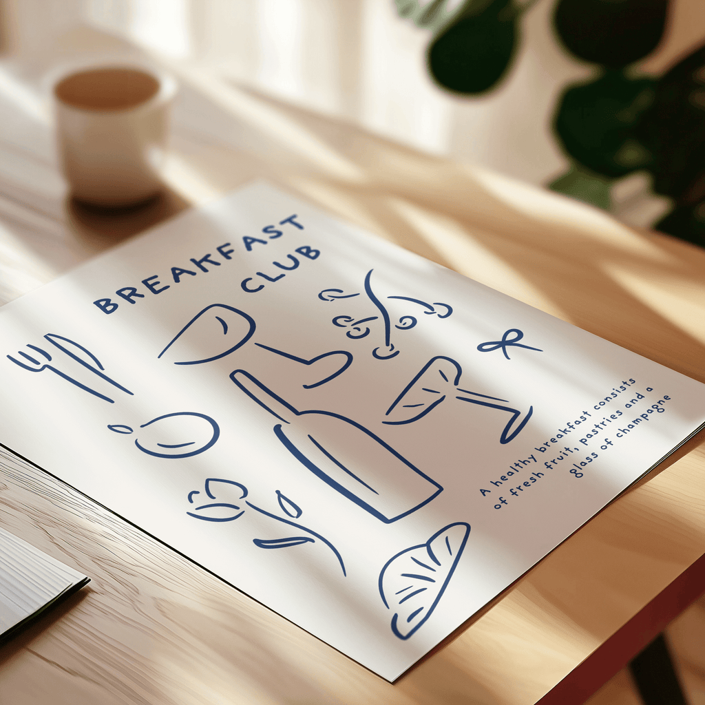 Art print with 'Breakfast Club' design on a wooden surface.