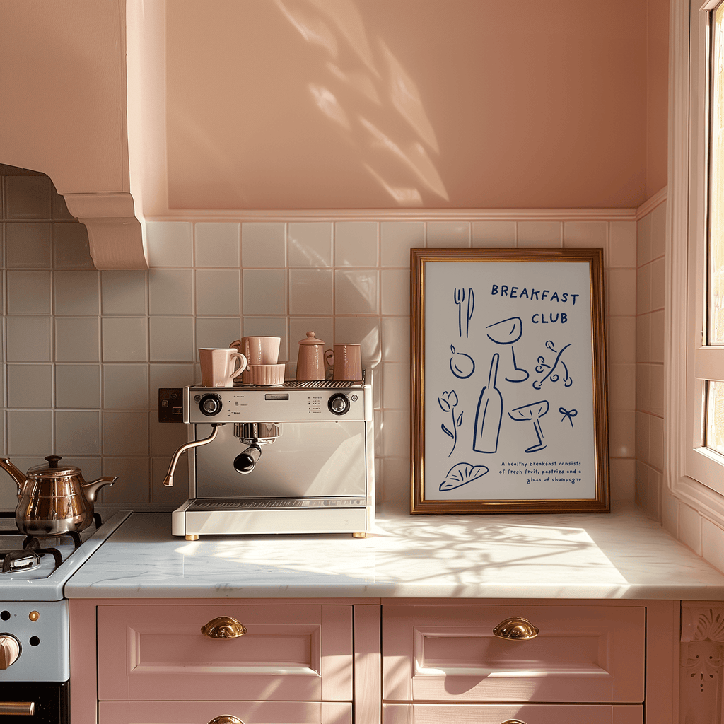 Kitchen with pink cabinets, espresso machine, and framed artwork on the wall.