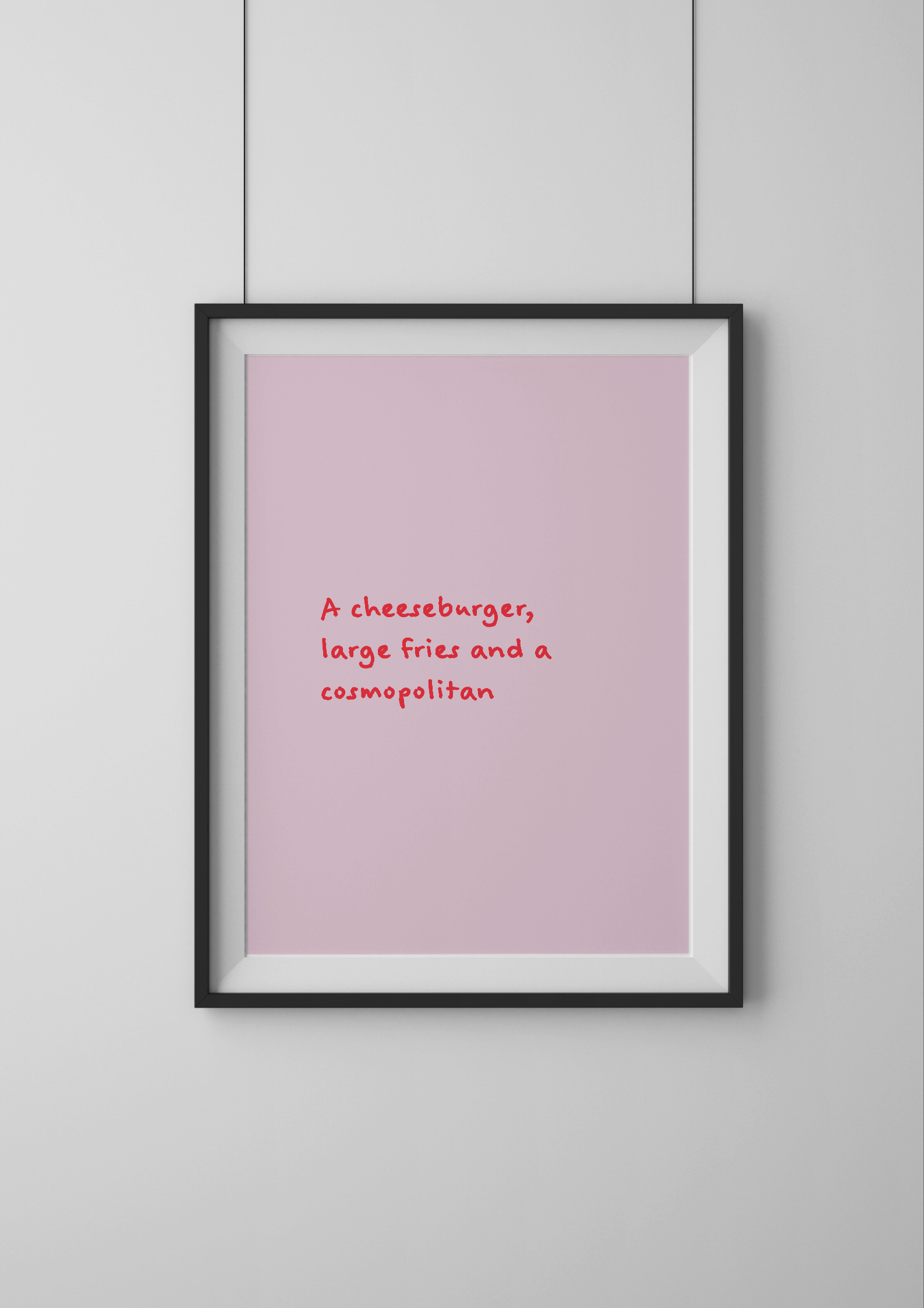 Framed pink poster with text on a white wall