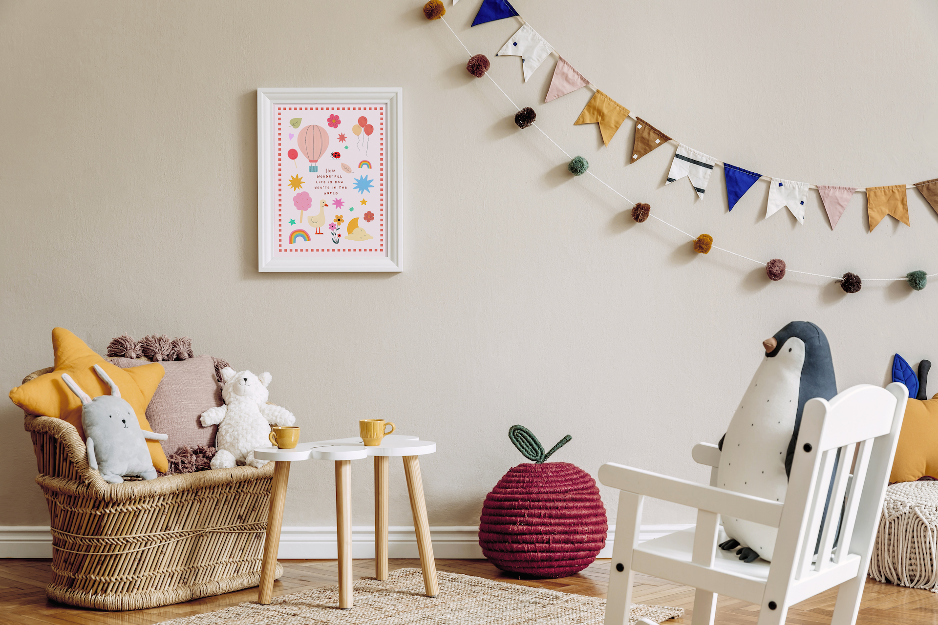 Children's room with toys, a chair, and decorative elements on a light-colored wall with framed children's wall art.