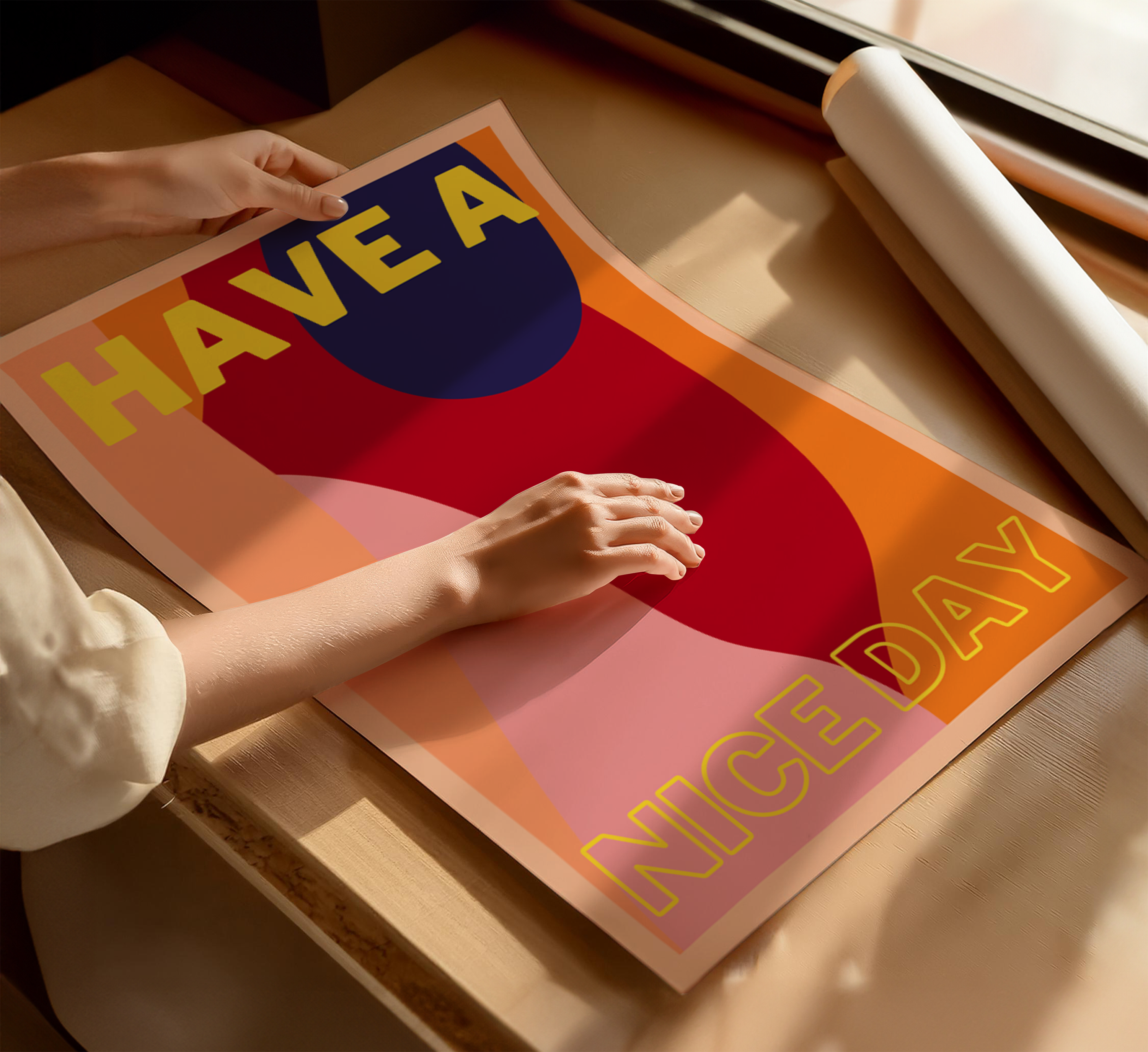 Person holding a colorful poster with text on a wooden surface