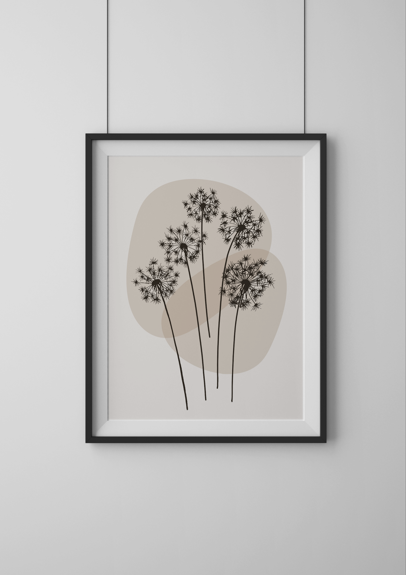 Framed artwork of black floral design on a beige background, hanging on a light gray wall.