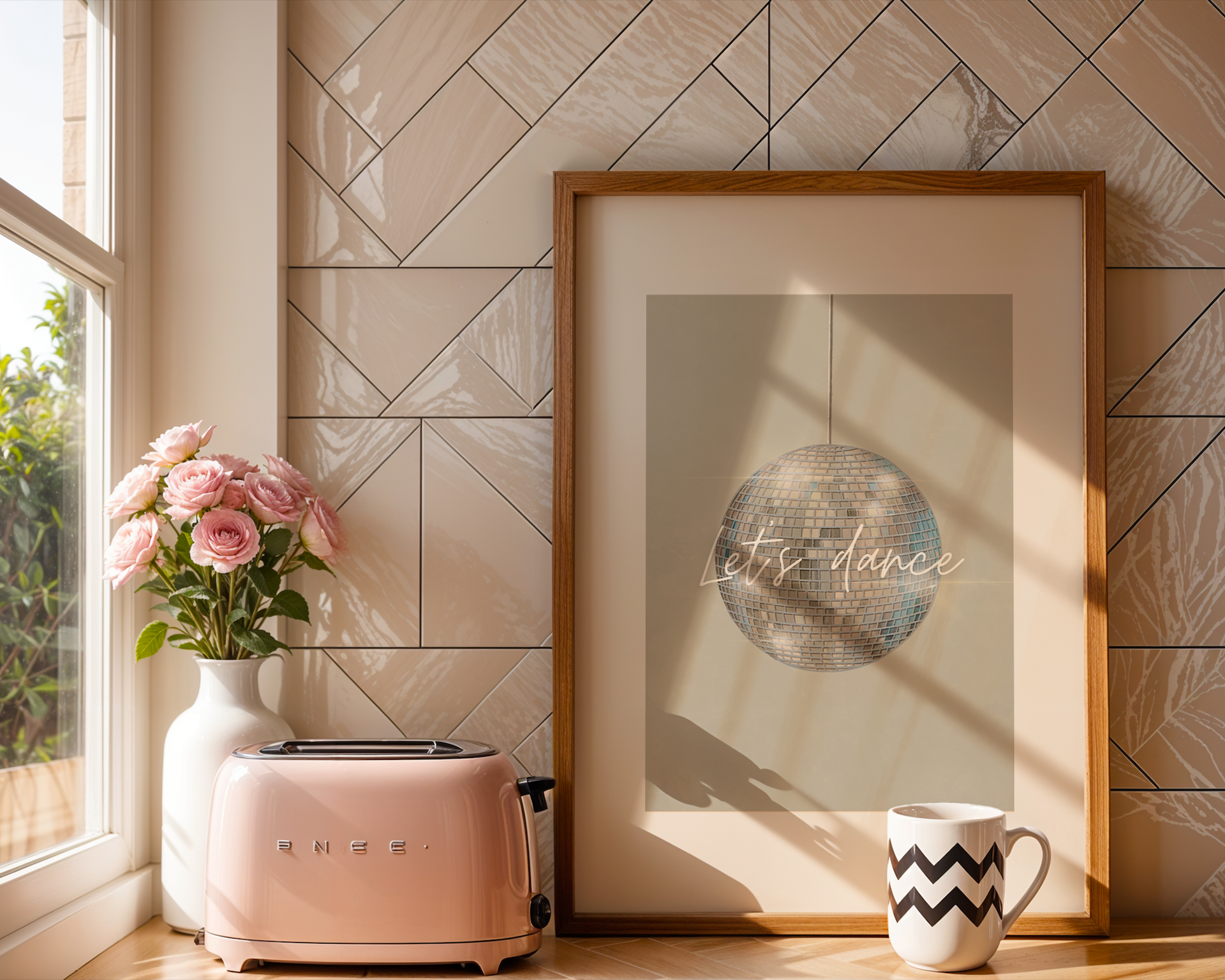 Pink toaster, vase with flowers, framed artwork, and mug on a tiled wall.