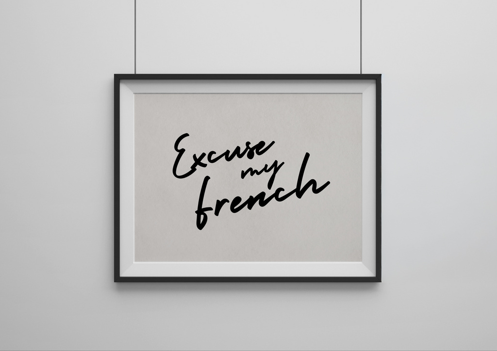 Framed artwork with 'Excuse my French' text on a plain wall