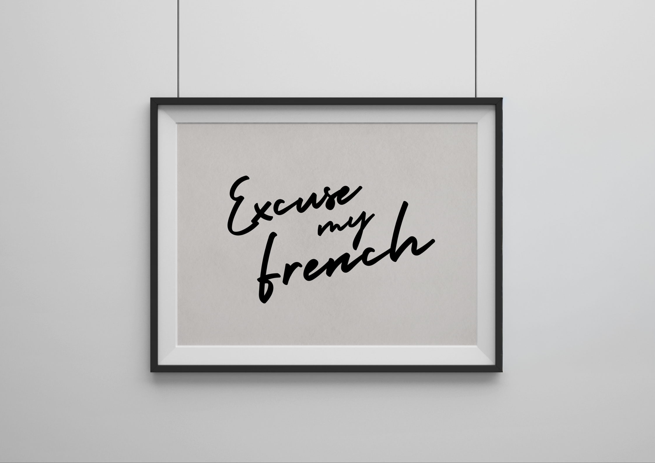 Framed artwork with 'Excuse my French' text on a plain wall
