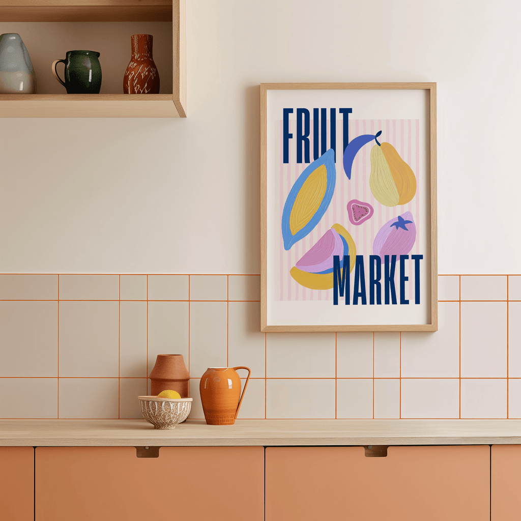 Framed artwork with 'Fruit Market' text and colorful fruit illustrations on a kitchen wall.