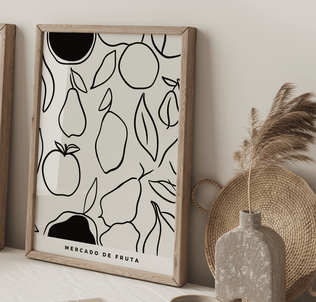 Framed artwork with fruit pattern on a wall next to decorative items