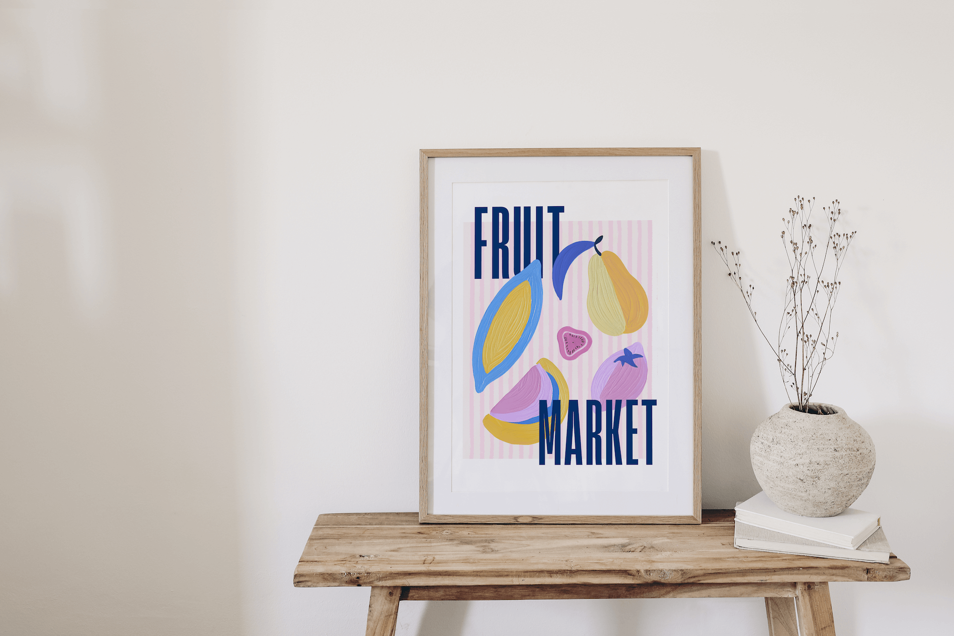 Framed artwork with colourful fruit illustrations and 'Fruit Market' text on a wooden table.