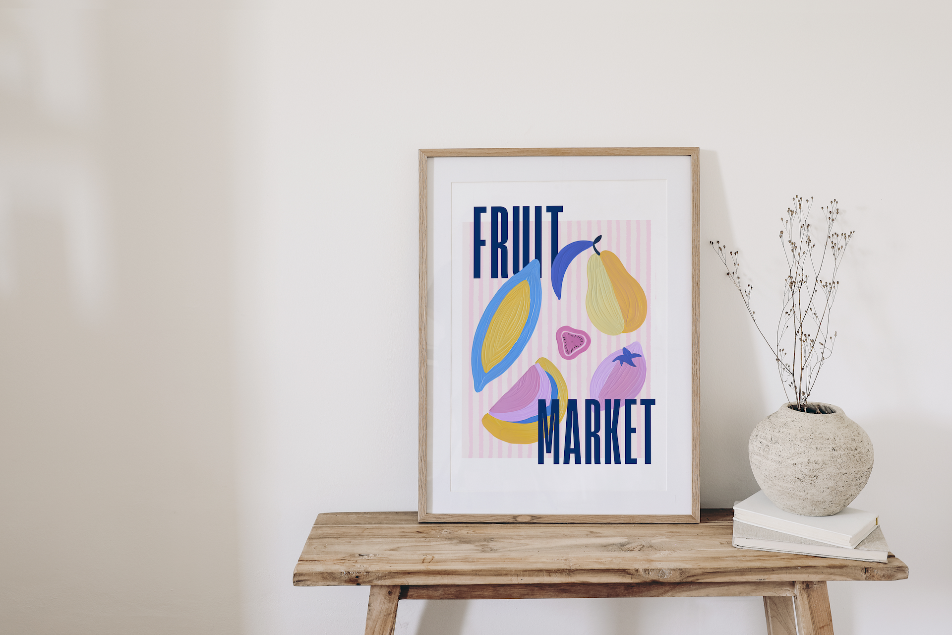 Framed artwork with colorful fruit illustrations and 'Fruit Market' text on a wooden table.