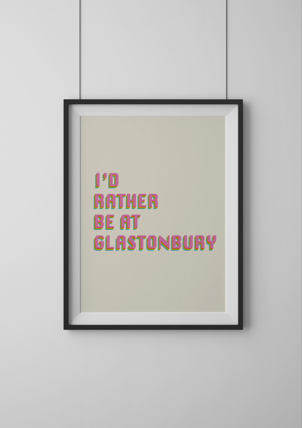 Framed print with 'I'd rather be at Glastonbury' text on a plain background