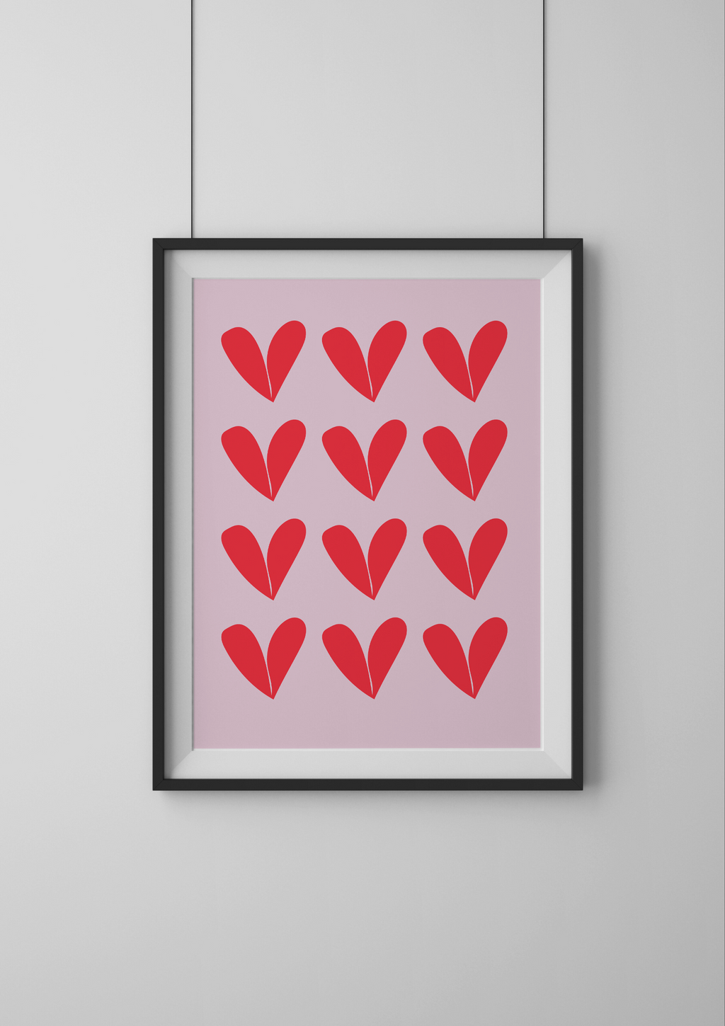 Framed artwork with red heart patterns on a pink background