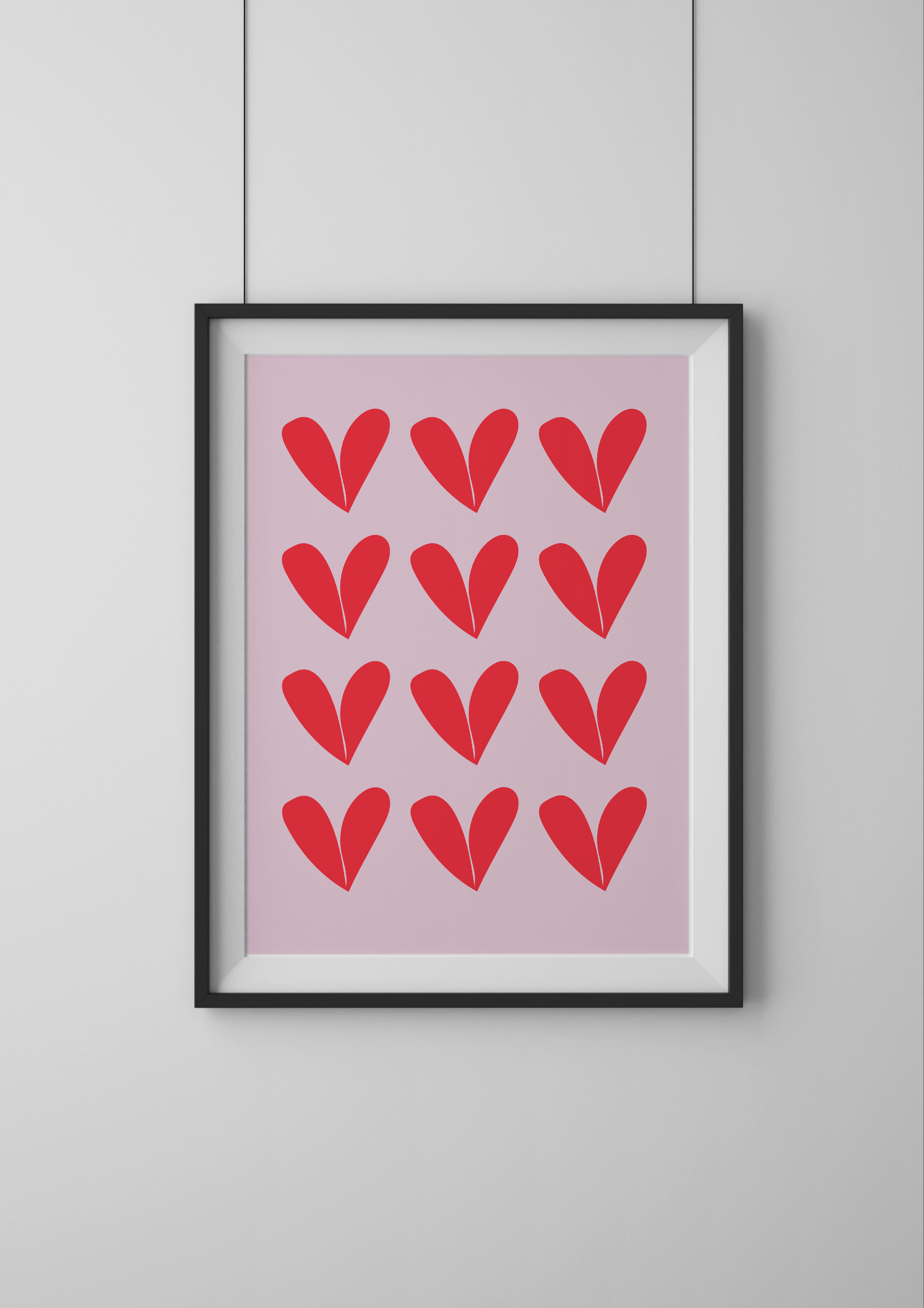 Framed artwork with red heart patterns on a pink background