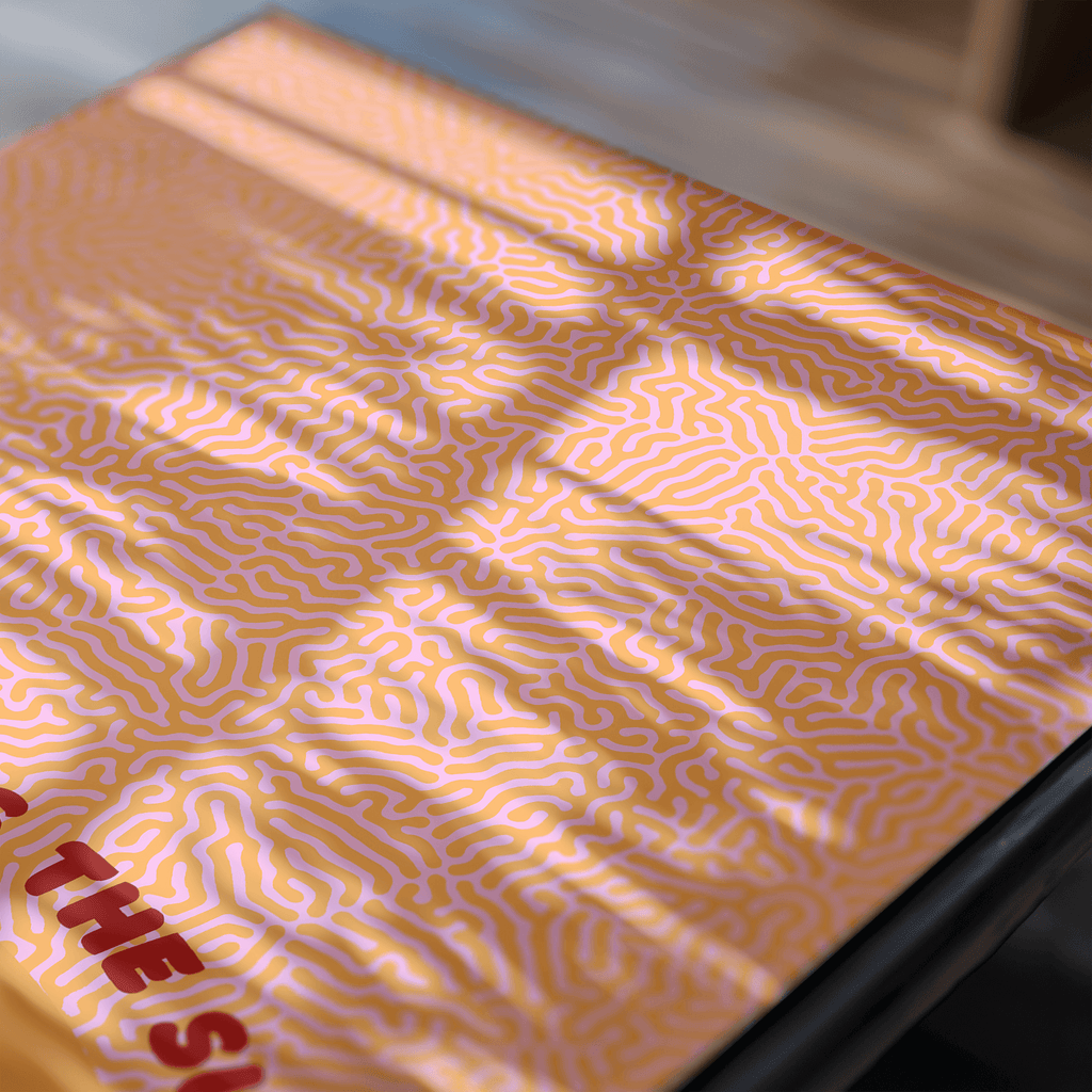 Close-up of a art print with a yellow and orange pattern on a table