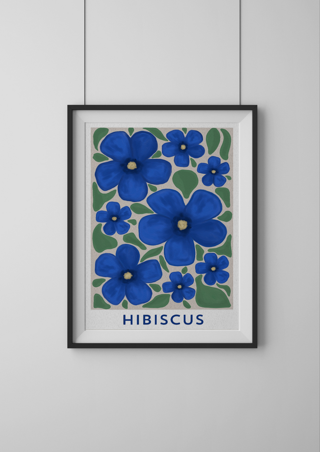 Framed artwork of blue hibiscus flowers on a white wall