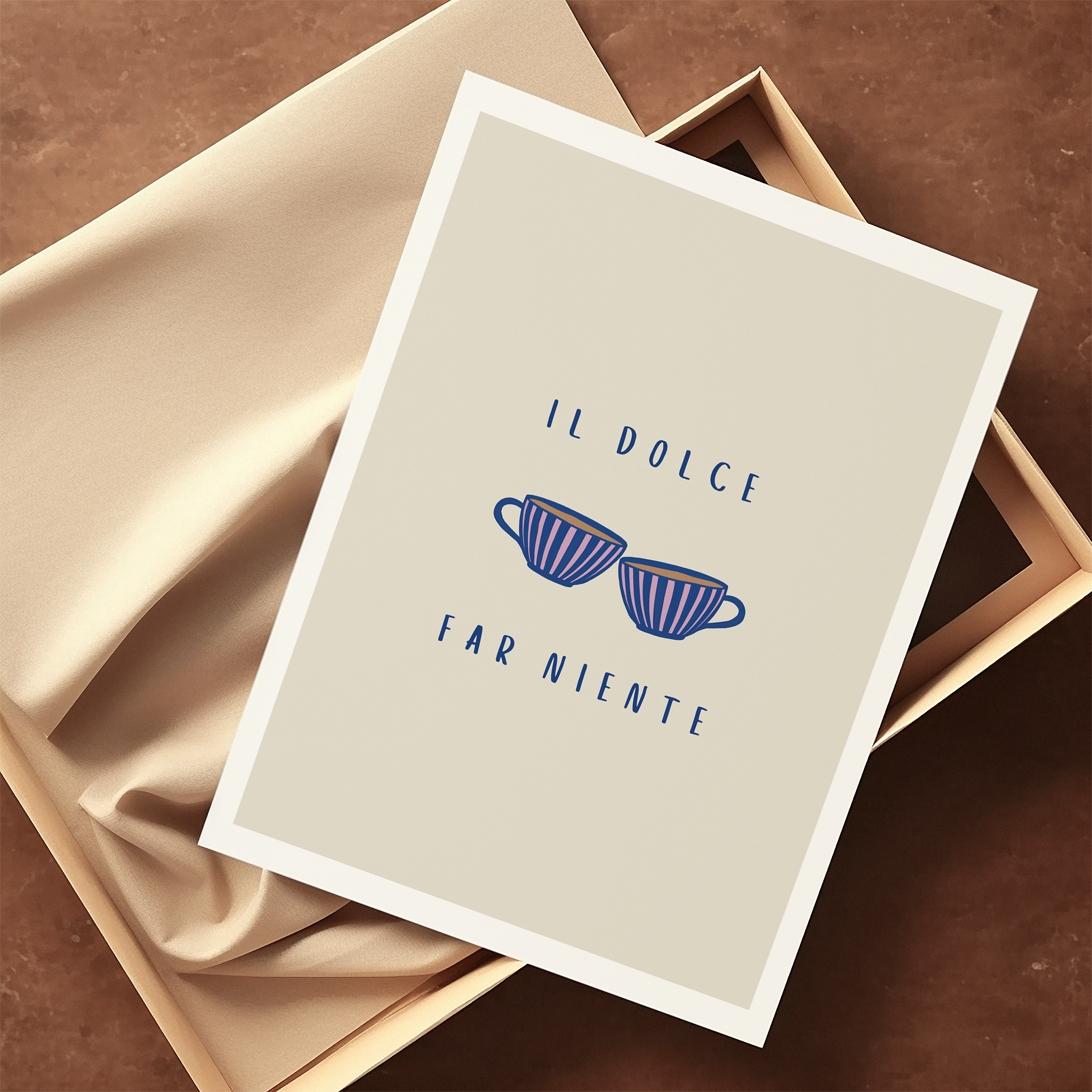 An art print featuring an illustration of two striped coffee cups and typography "il dolce far niente" laying on top of sustainable packaging.