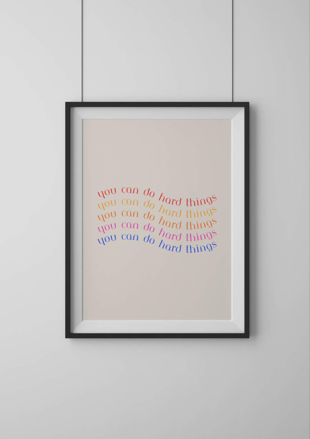 Framed artwork with colorful text on a beige background