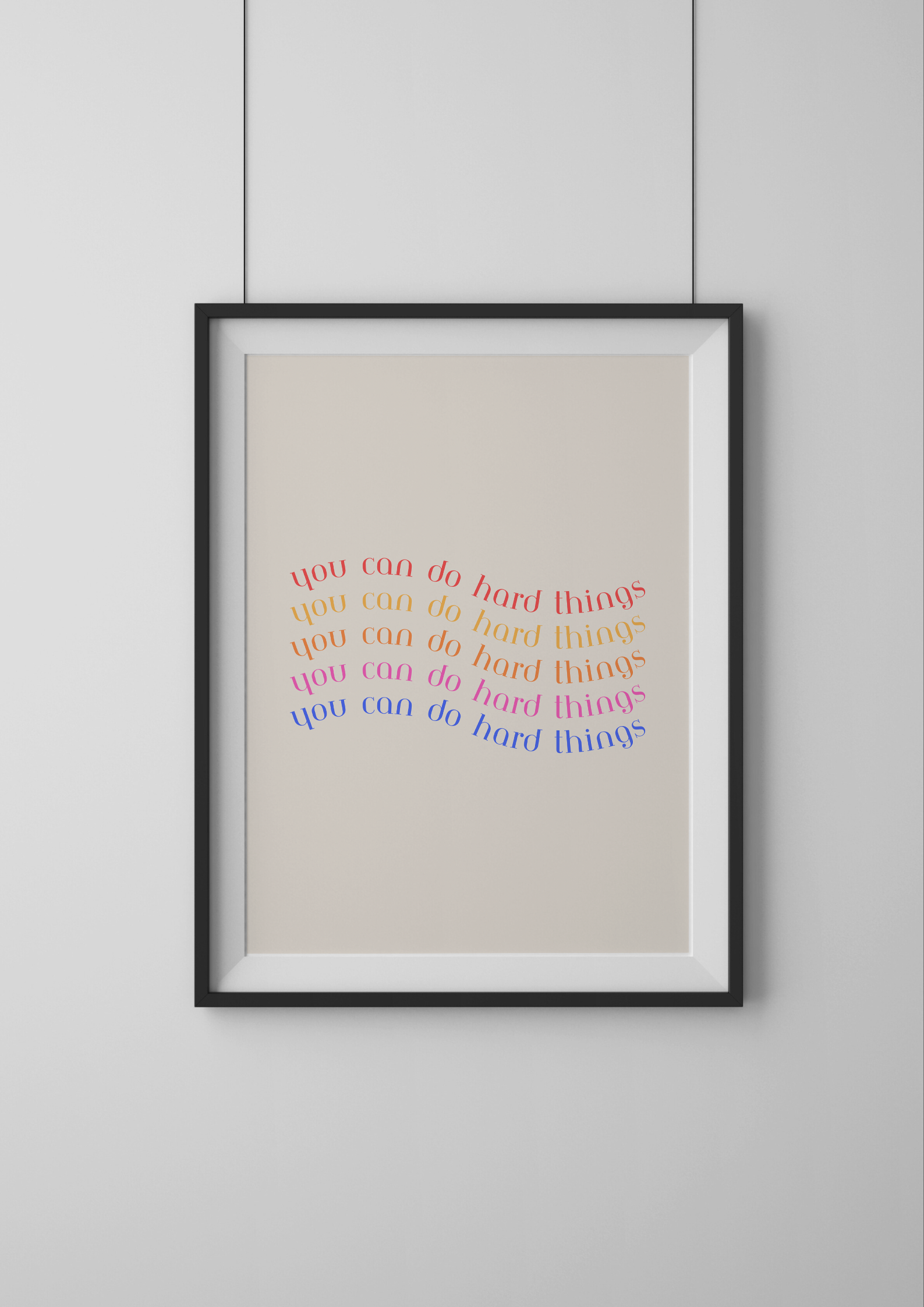 Framed artwork with colorful text on a beige background