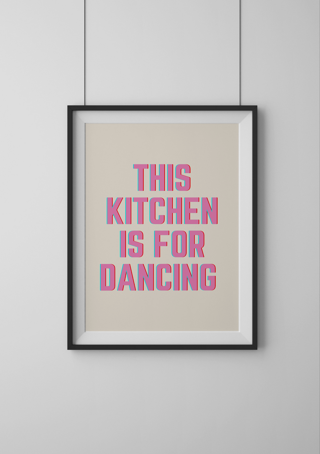 Framed poster with 'This kitchen is for dancing' text on a beige background