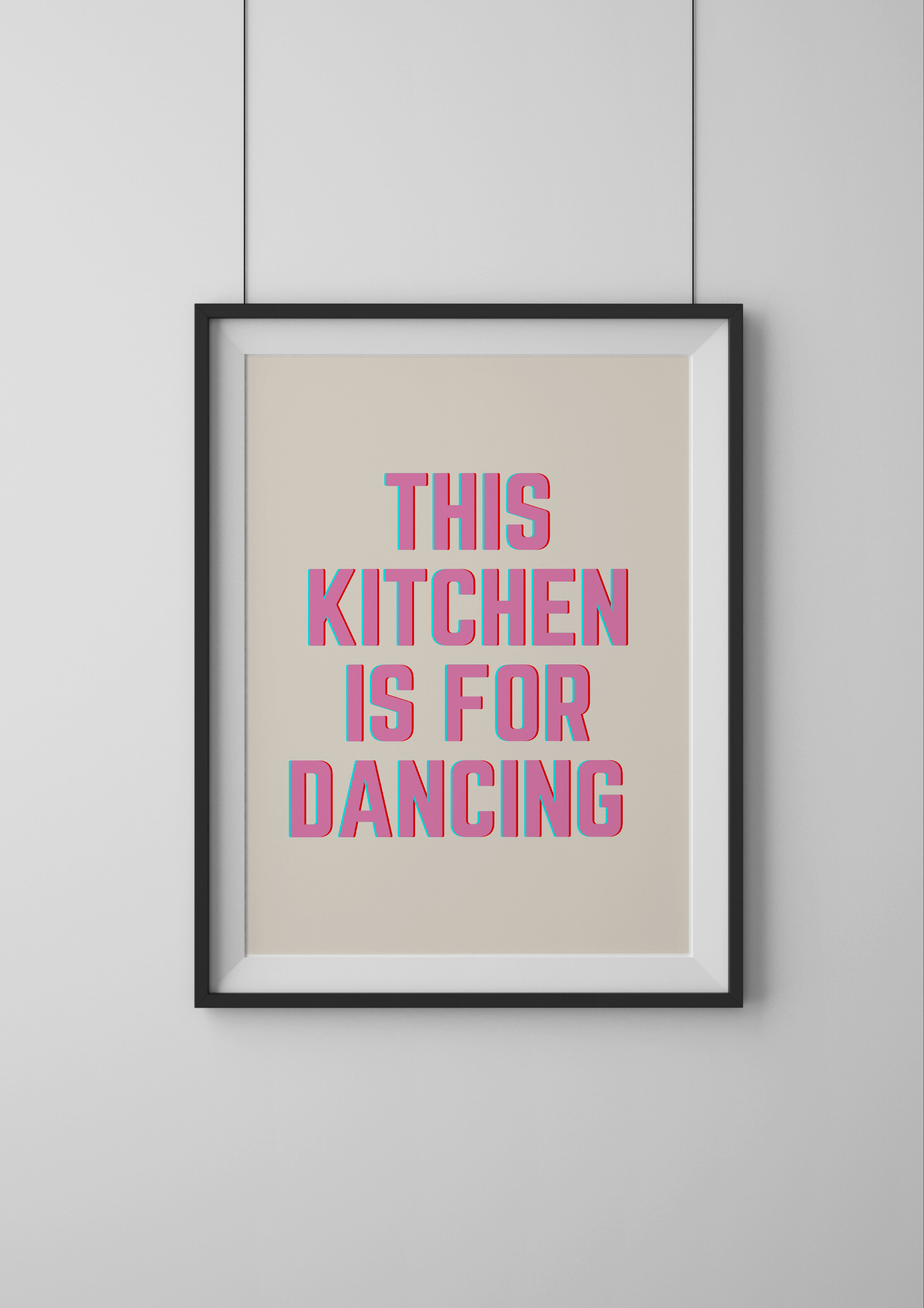 Framed poster with 'This kitchen is for dancing' text on a beige background