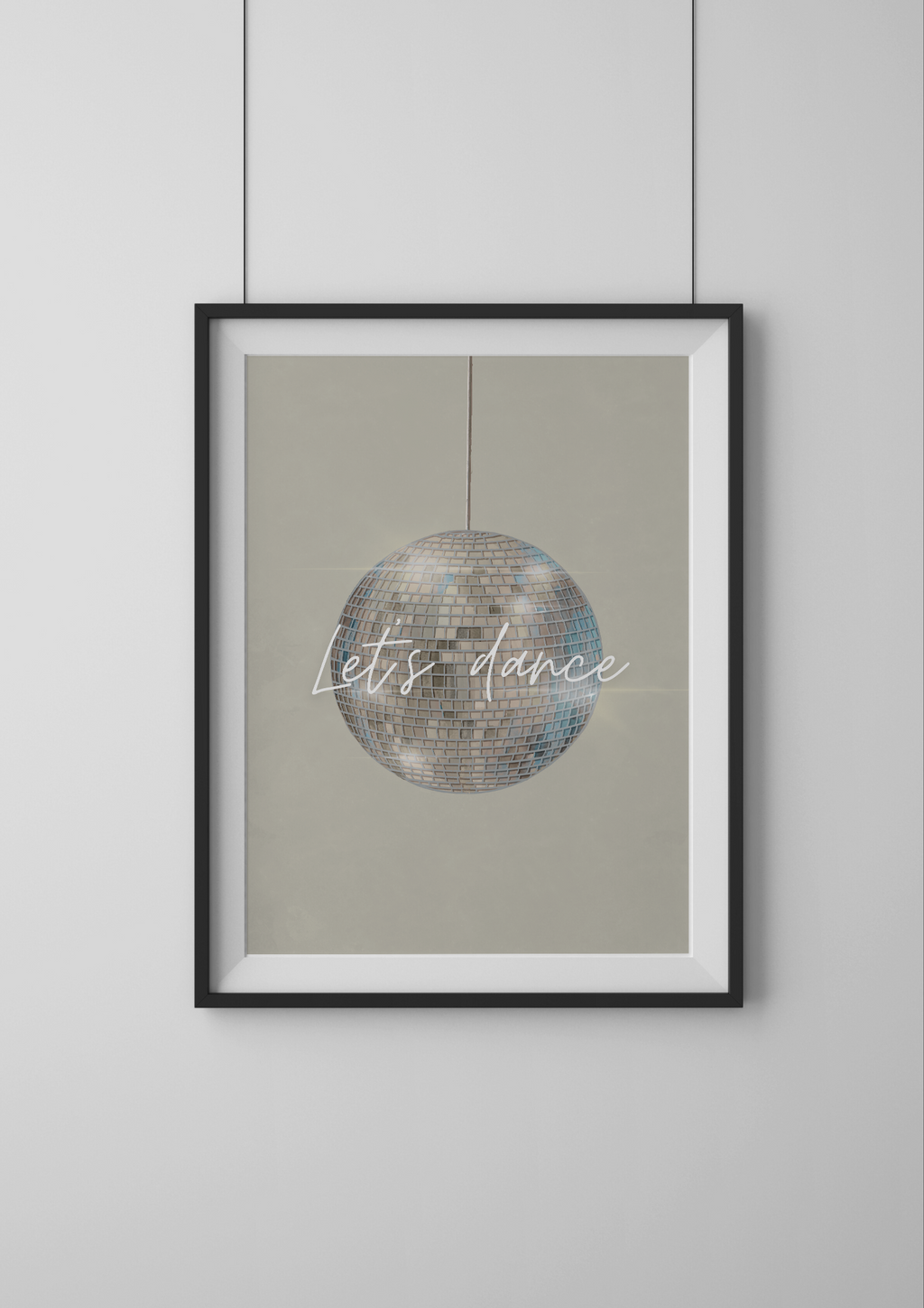 Framed artwork with disco ball and 'Let's dance' text on a beige background