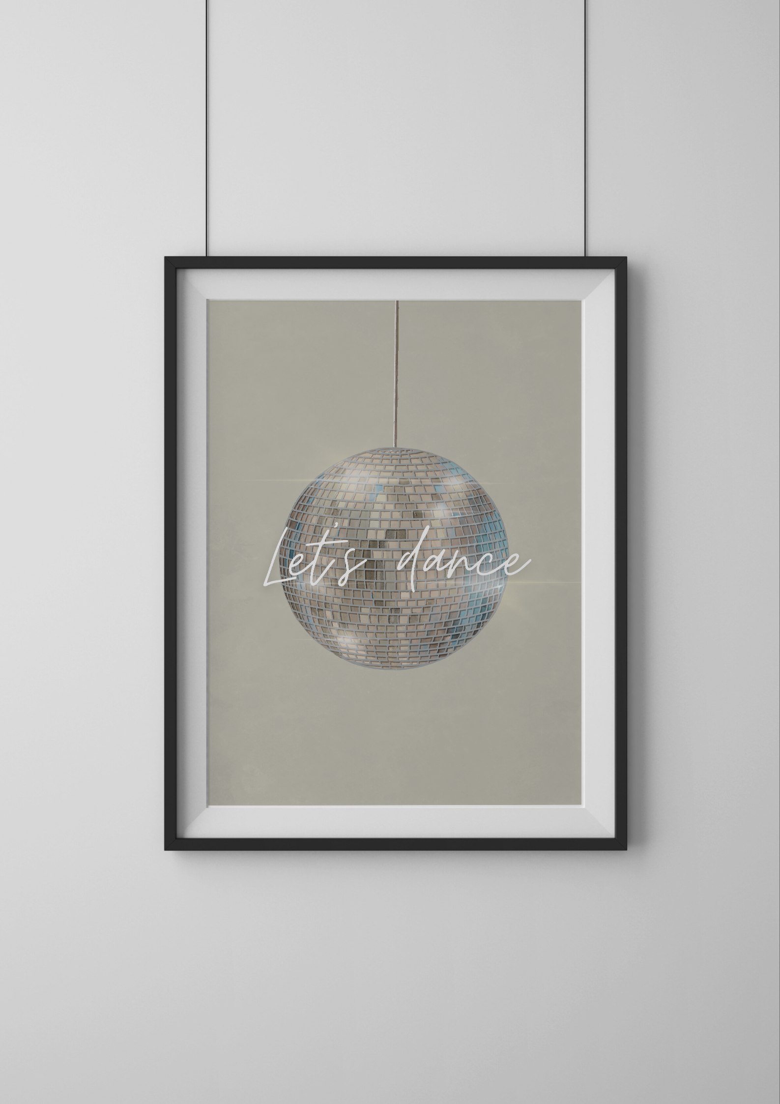 Framed artwork with disco ball and 'Let's dance' text on a beige background