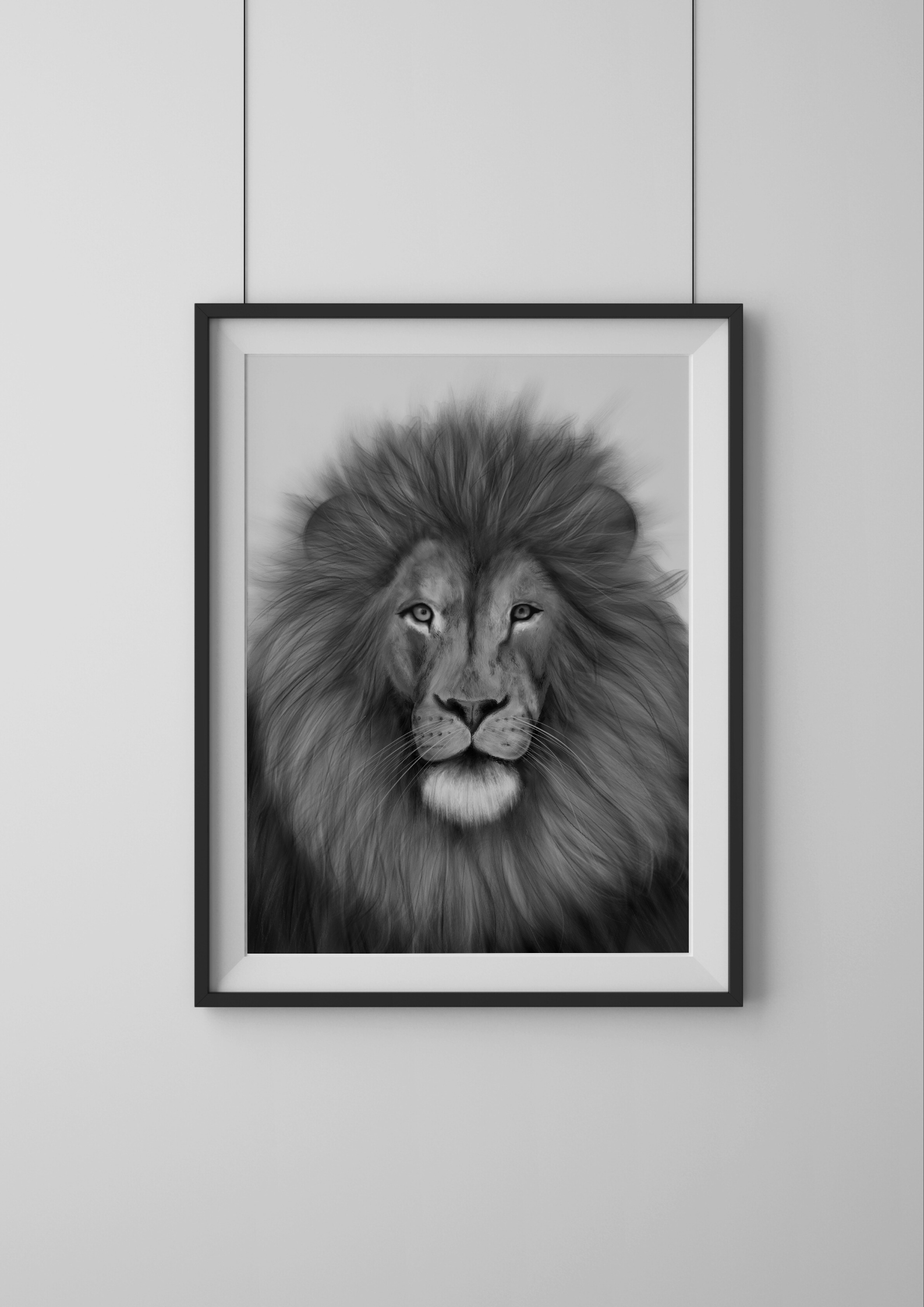 Framed black and white portrait of a lion on a light gray wall