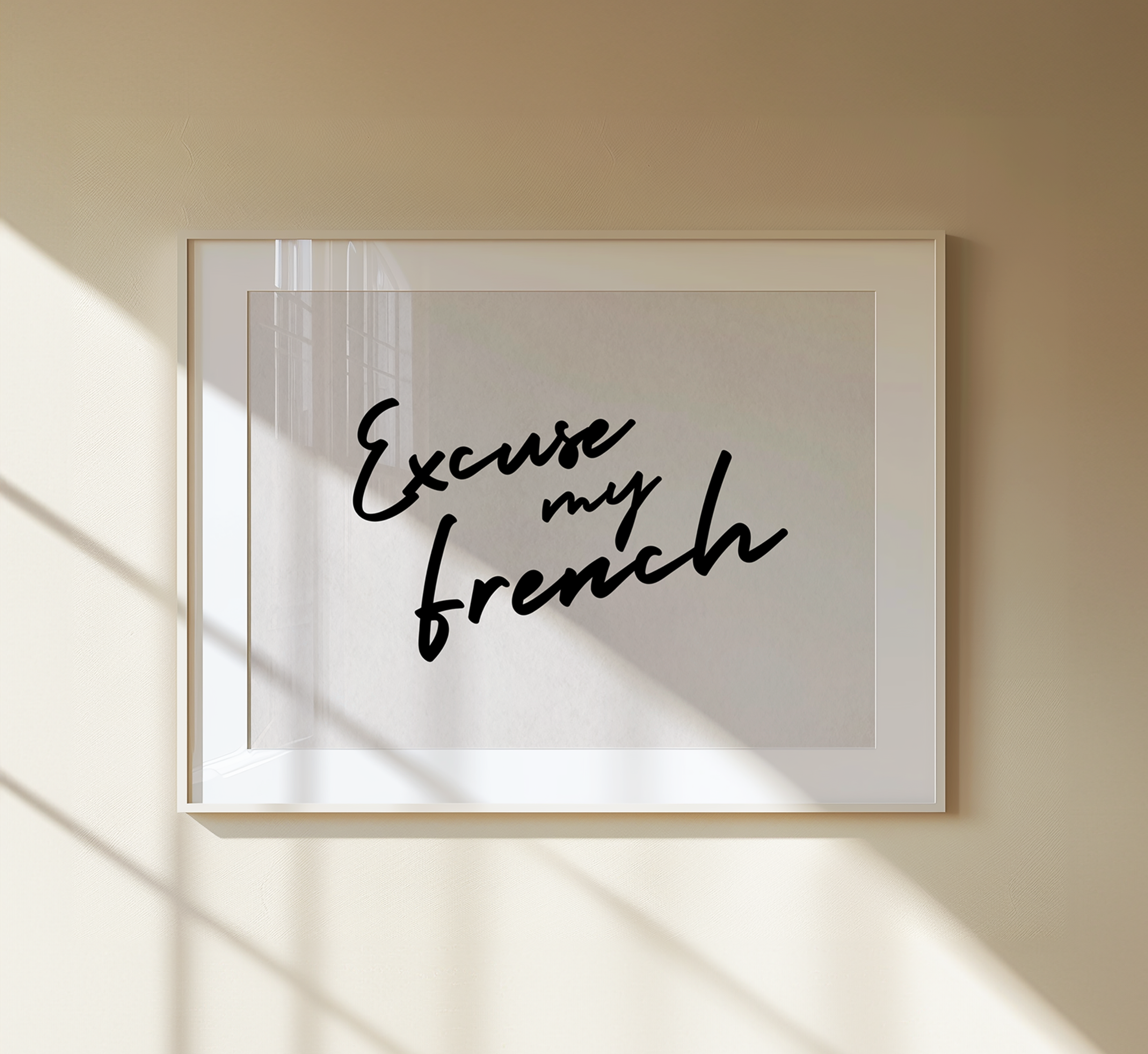 Framed artwork with 'Excuse my French' text on a beige wall.