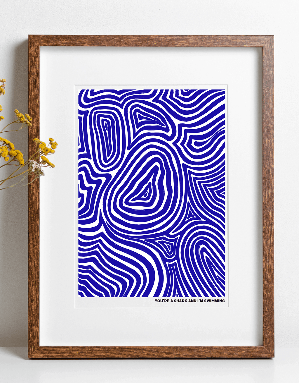 An art print featuring blue illustration in swirl design with lyrics from alt-J "You're a shark and I'm swimming"