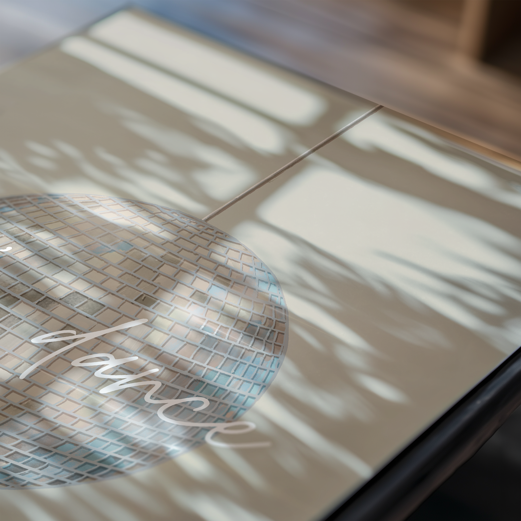 Close-up of a disco ball print on a reflective surface.