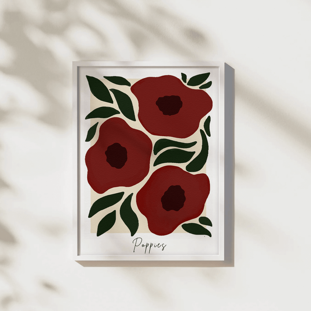 Framed artwork with red poppies and green leaves on a white background