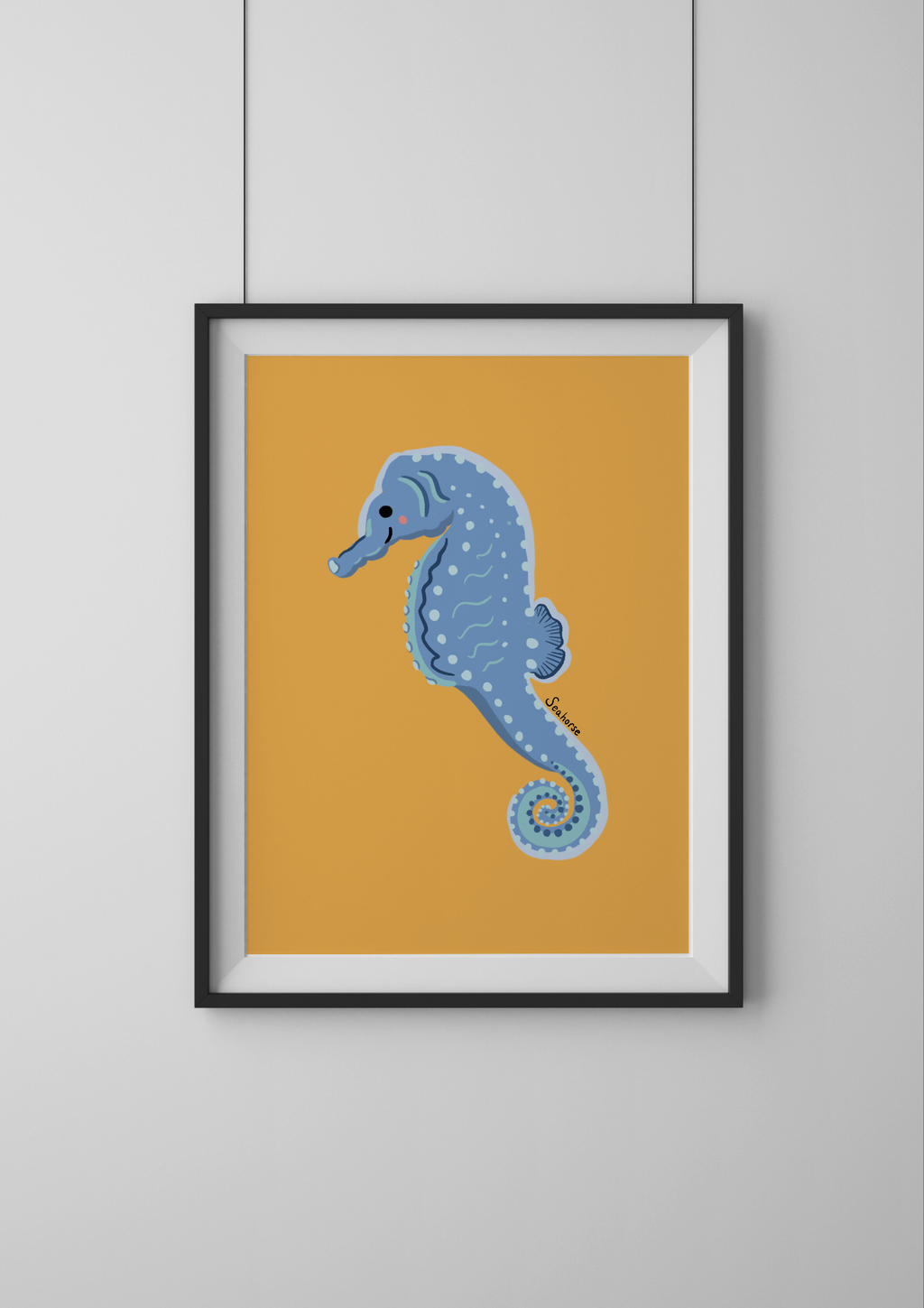 Framed artwork of a blue seahorse on a yellow background