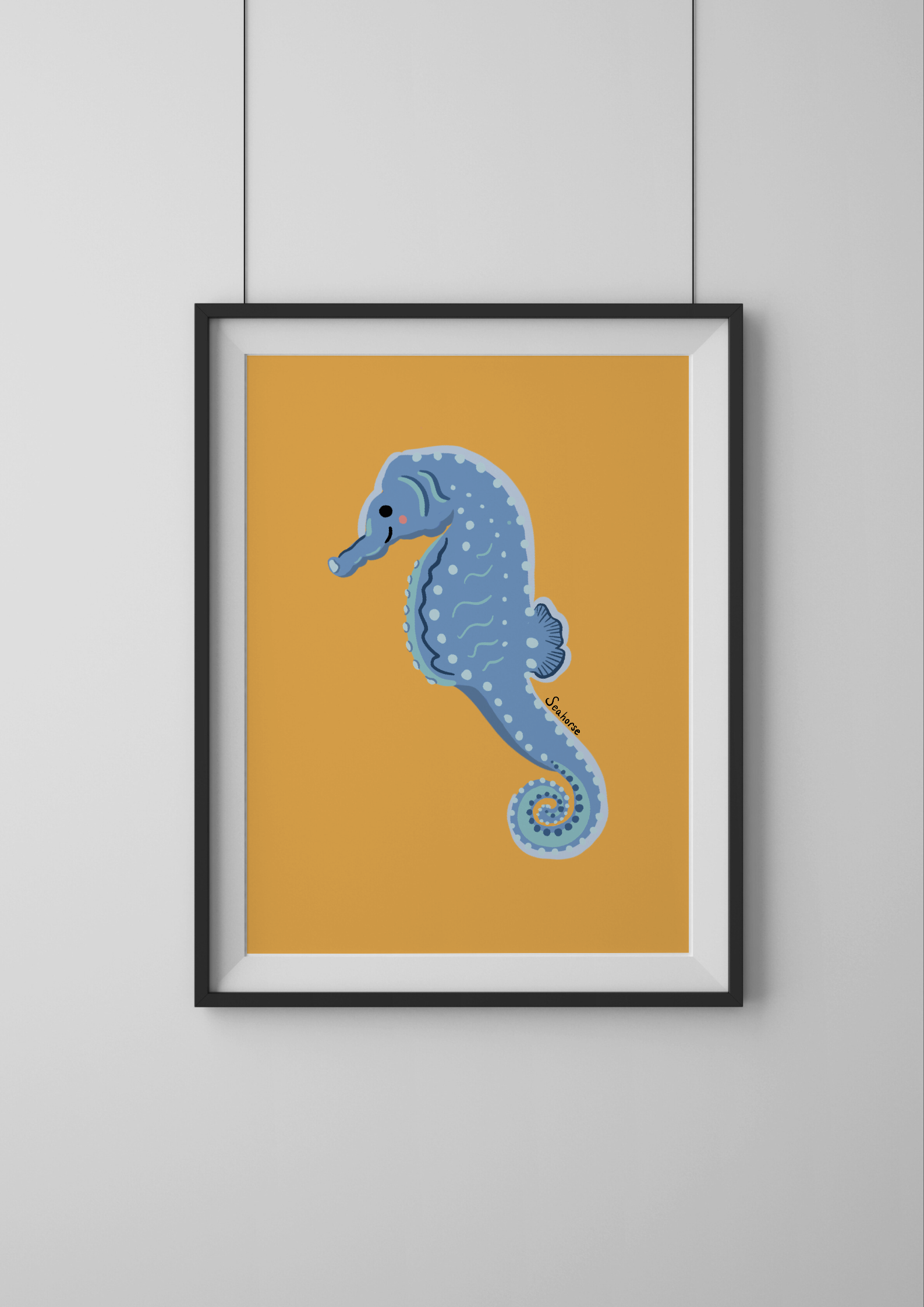 Framed artwork of a blue seahorse on a yellow background