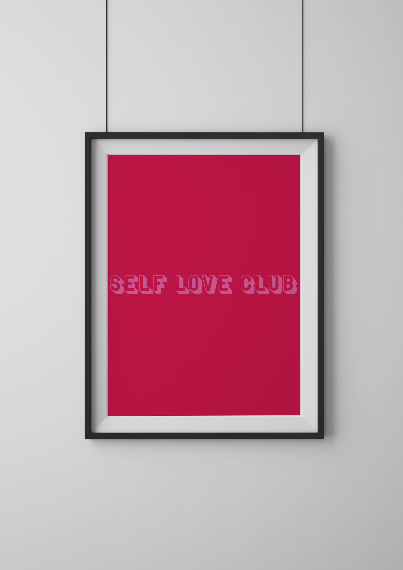 Framed poster with 'SELF LOVE CLUB' text on a red background, mounted on a light gray wall.