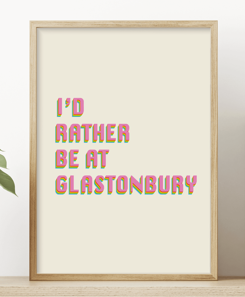 Art print featuring text "I'd rather be in Glastonbury" in pink colours against a beige background