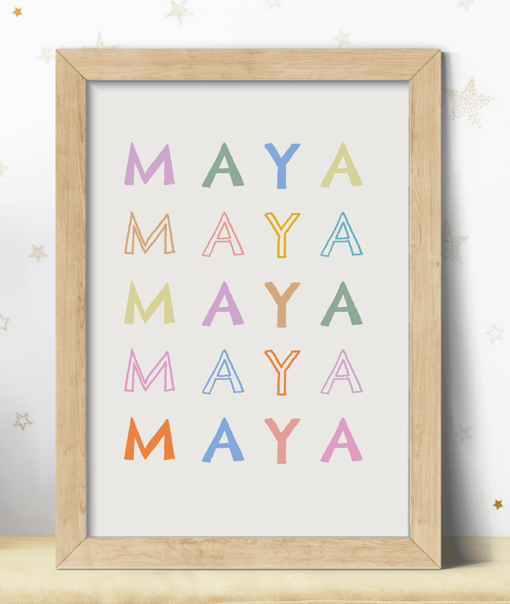 Personalised name print in pastel colours against a light background in a wooden frame