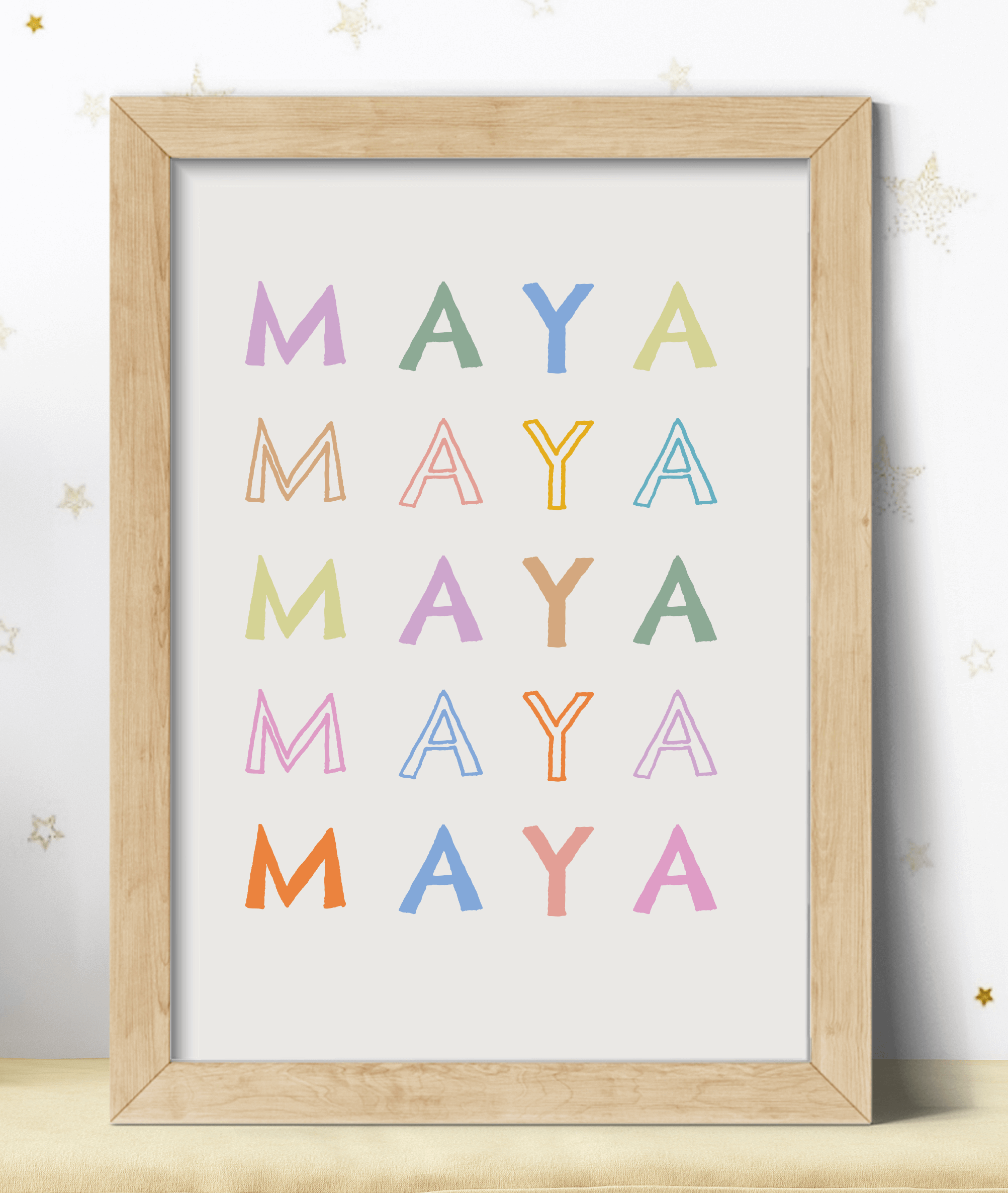 Personalised name print in pastel colours against a light background in a wooden frame